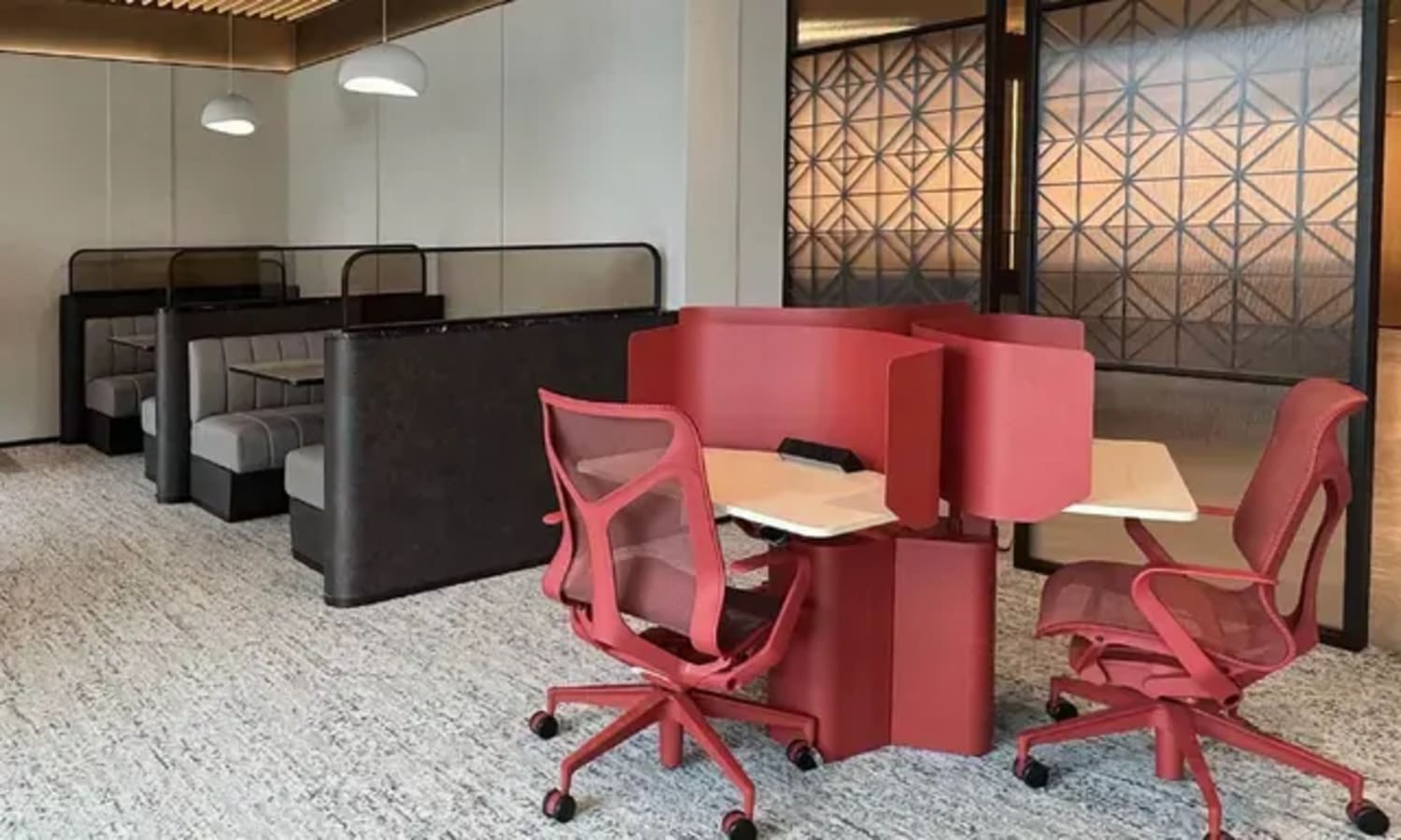 Modern coworking space with ergonomic chairs, private booths, and stylish decor. Ideal for productivity.