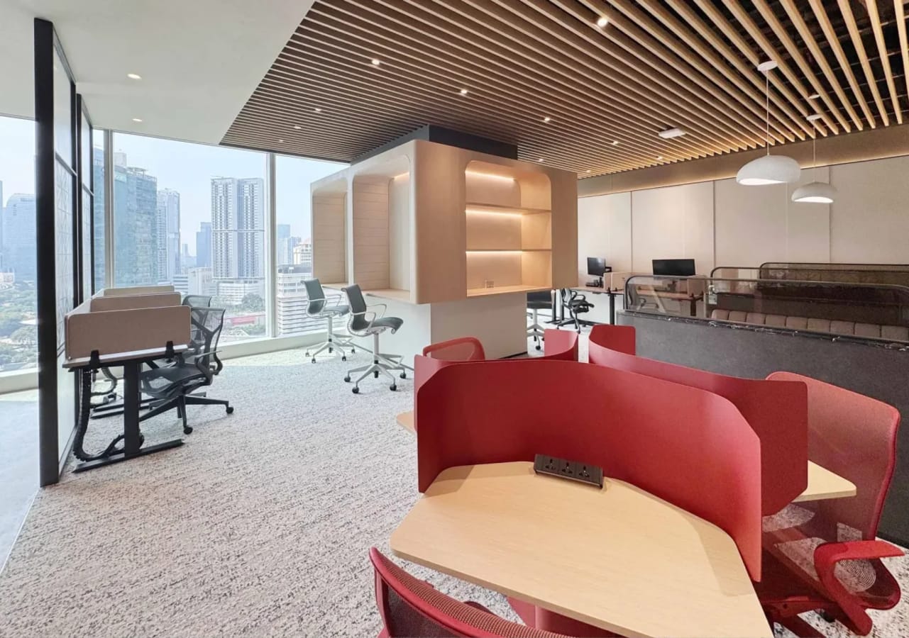 Modern coworking space with city views, stylish furnishings, and ample natural light.
