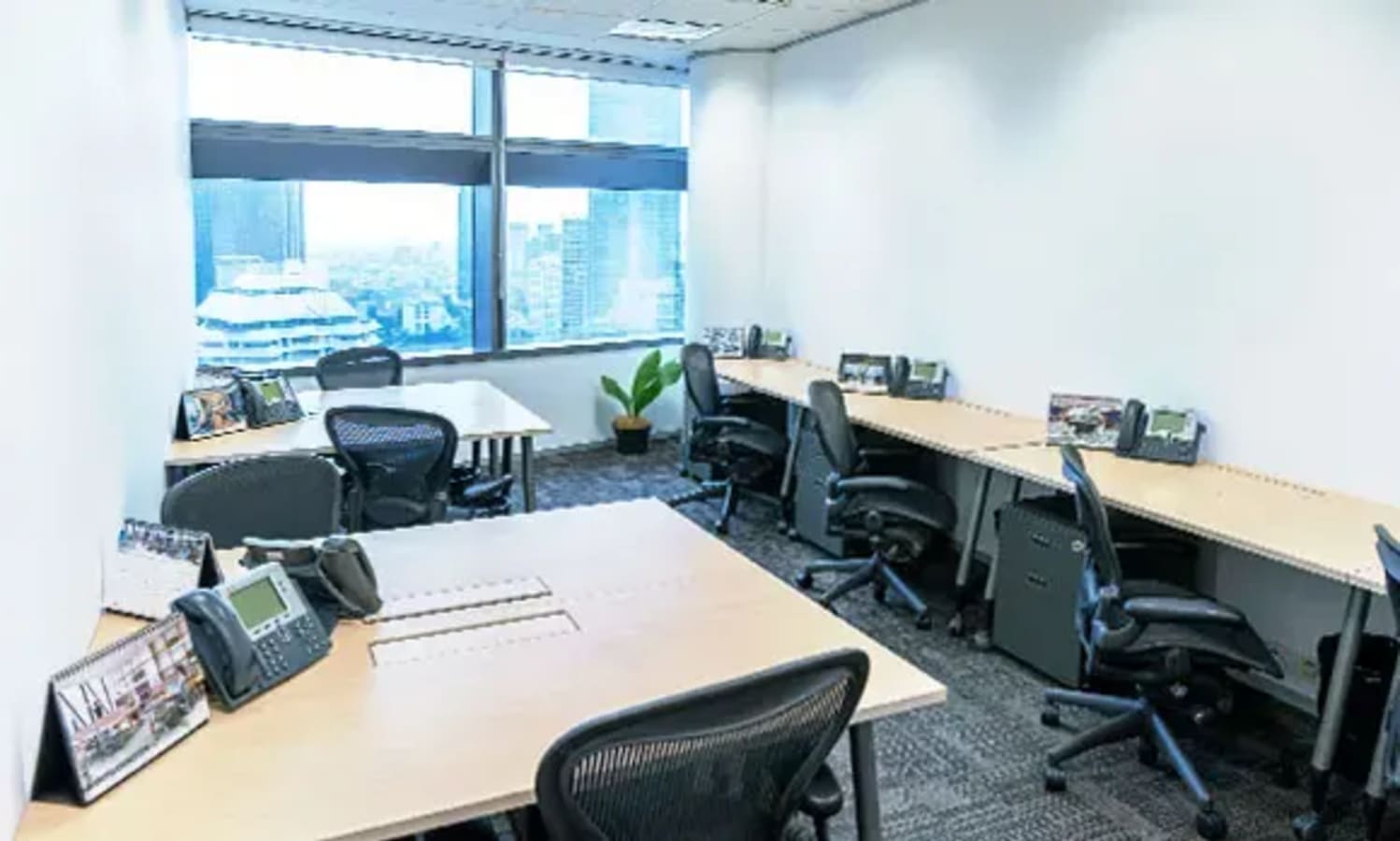Modern coworking space in Jakarta with ergonomic chairs and city views.