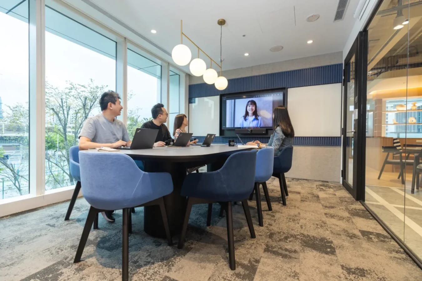 Modern meeting room in Taipei coworking space, featuring tech amenities and abundant natural light.
