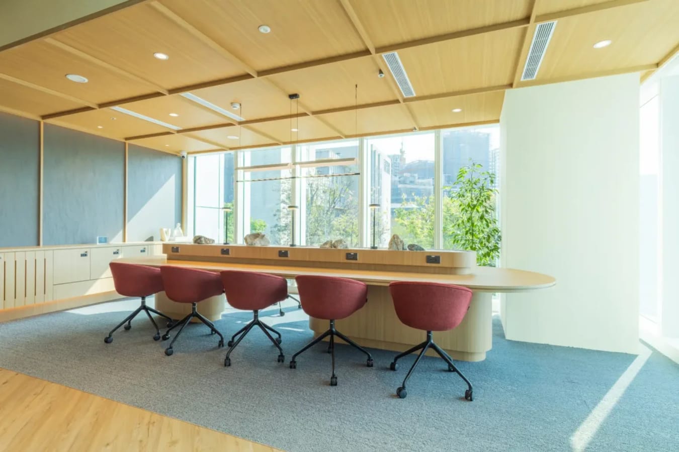 Modern coworking space with natural light, ergonomic chairs, and a collaborative desk in Taipei.