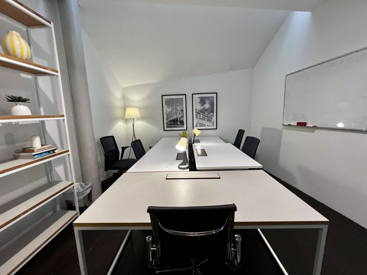 Modern coworking space with sleek desks, warm lighting, and a collaborative atmosphere.