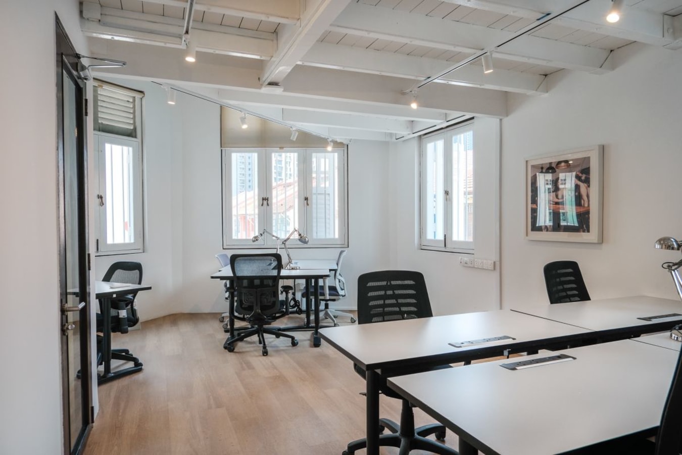 Bright, airy coworking space with modern desks and ergonomic chairs on Keong Saik Road.