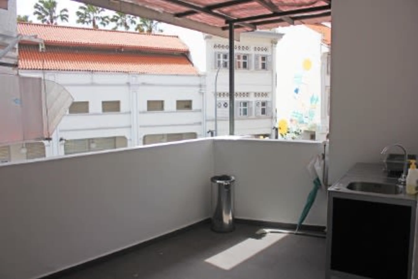 Bright balcony area with city views, perfect for breaks or casual meetings.