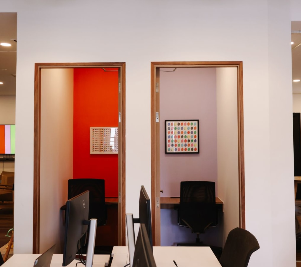 Private focus booths with vibrant accents in a modern coworking space on Neil Road, Singapore.