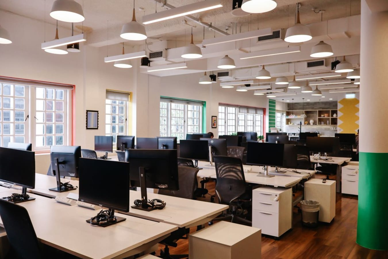Bright, open coworking space with modern desks and ample natural light on Neil Road.