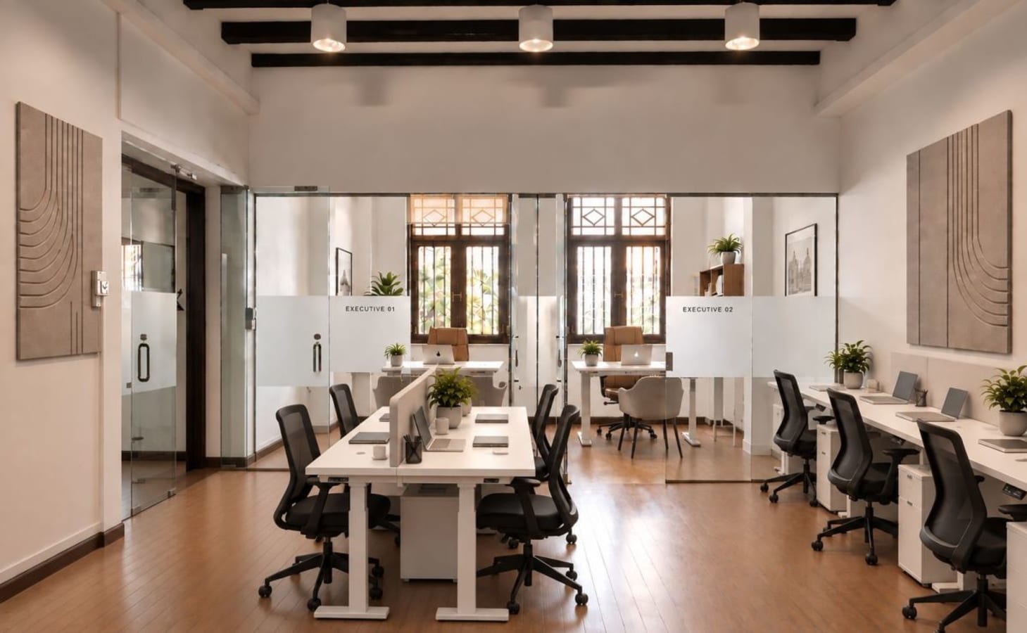 Modern coworking space with natural light, sleek desks, and private meeting rooms.