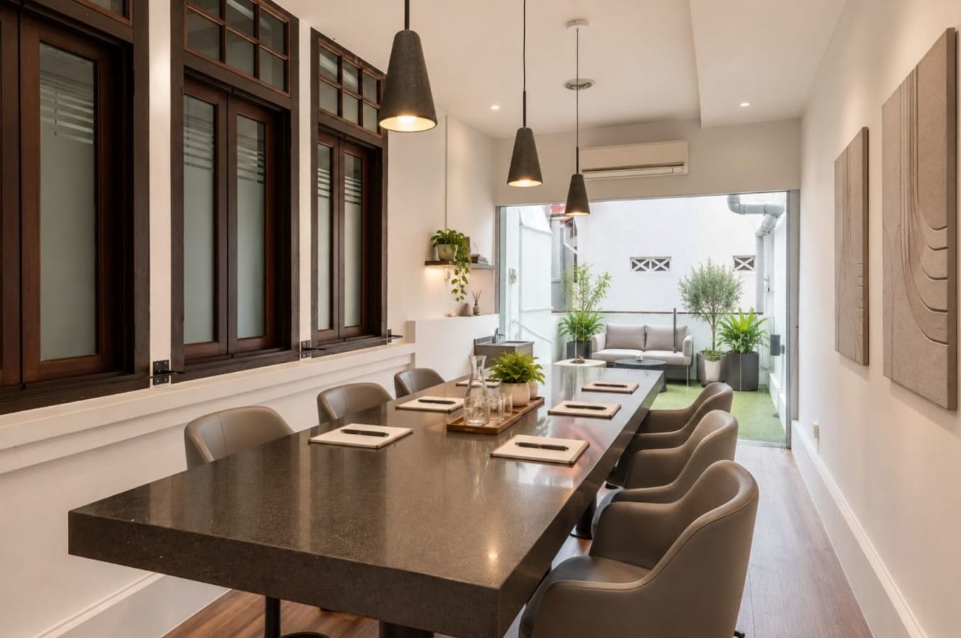 Chic coworking space with elegant meeting area, modern decor, and abundant natural light.