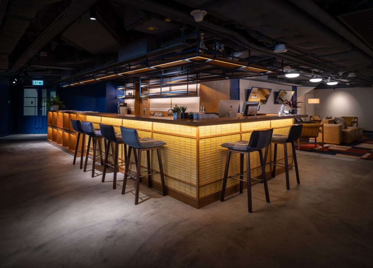 Stylish coworking space with a well-lit bar, cozy seating, and modern design on Nathan Road.