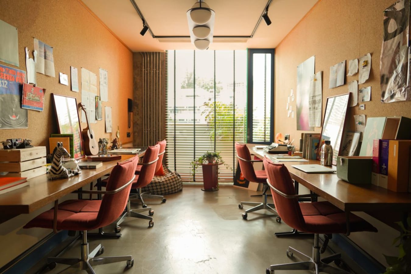 Bright, creative coworking space with ample natural light and collaborative seating.