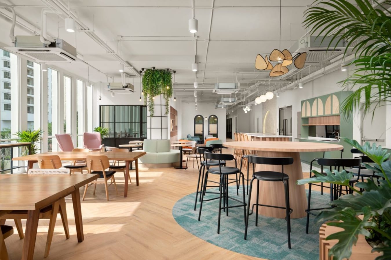 Bright, modern coworking space with versatile seating, natural light, and stylish decor.