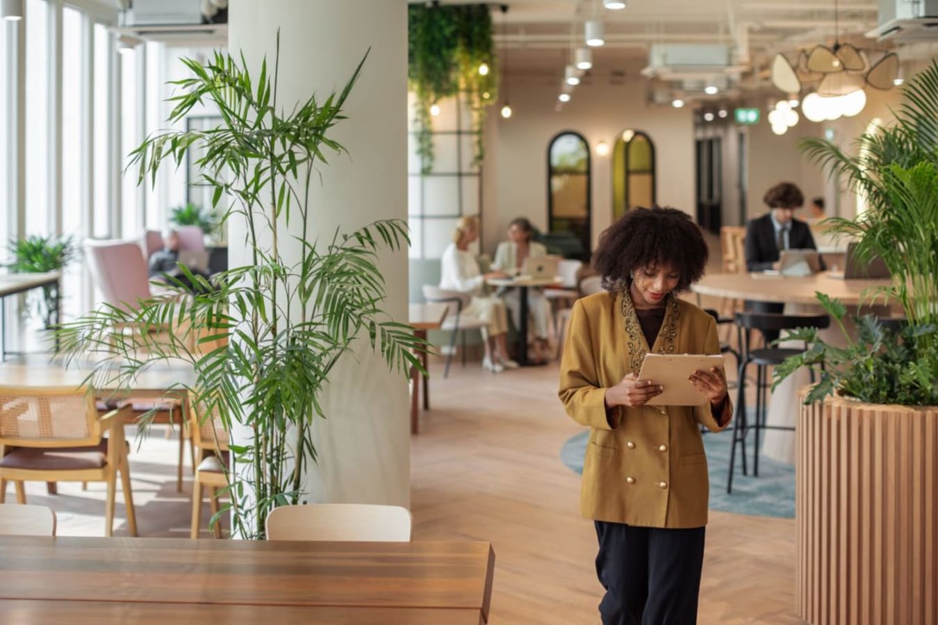 Bright, open coworking space with lush greenery and flexible seating in Thanon Phloen Chit.