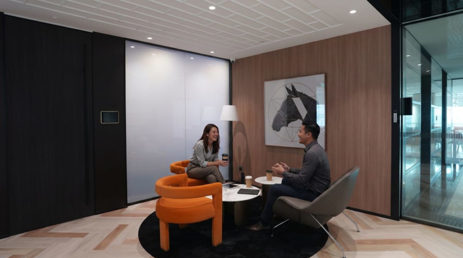 Modern coworking area with cozy seating and contemporary art, perfect for collaboration.