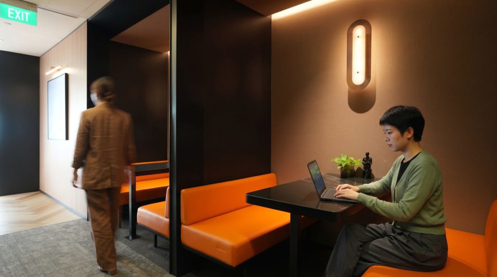Stylish coworking booths with modern lighting and comfortable seating in The Gateway, Singapore.