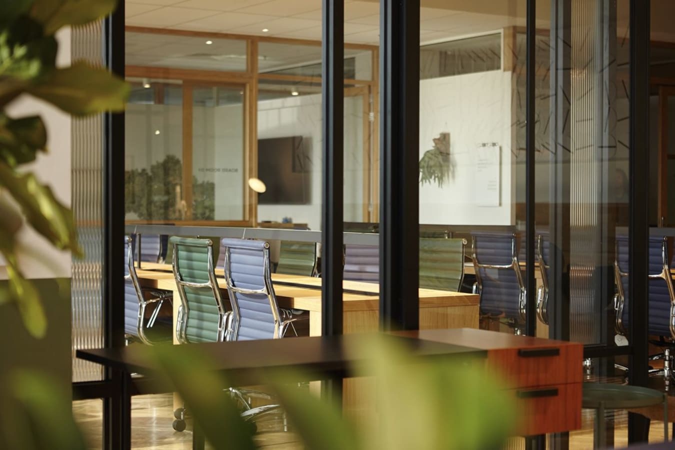 Modern coworking space with sleek chairs, abundant natural light, and a collaborative atmosphere.