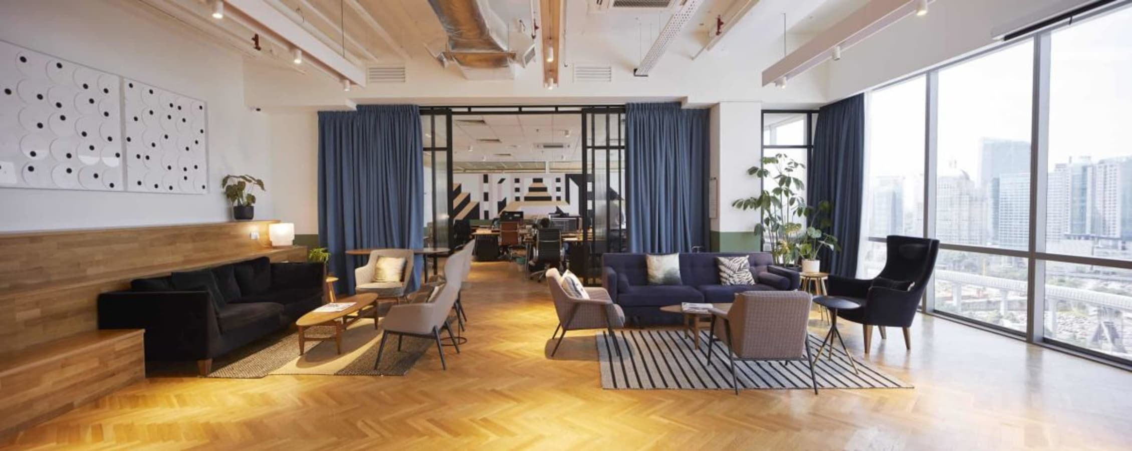 Elegant coworking space with city views, cozy seating, and abundant natural light in Changkat Semantan.