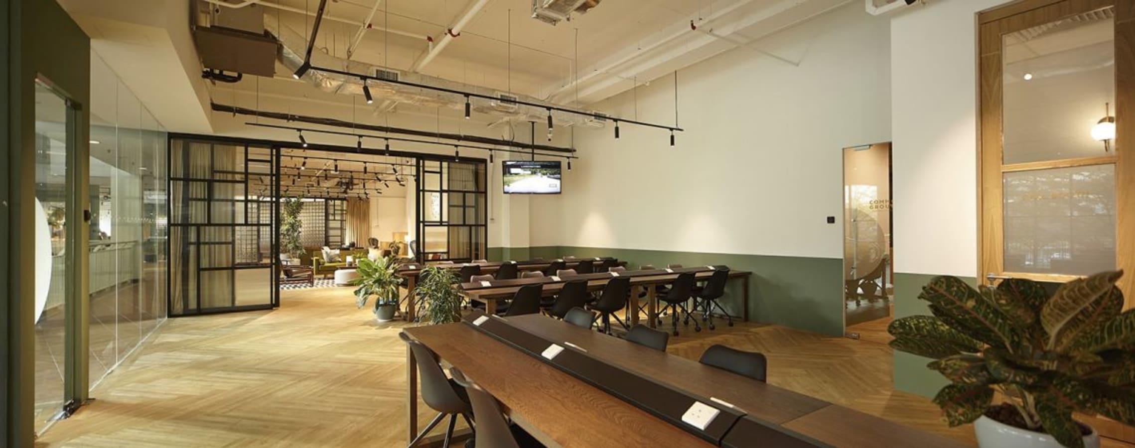 Modern coworking space with open layout, ample seating, and natural lighting. Ideal for productivity.