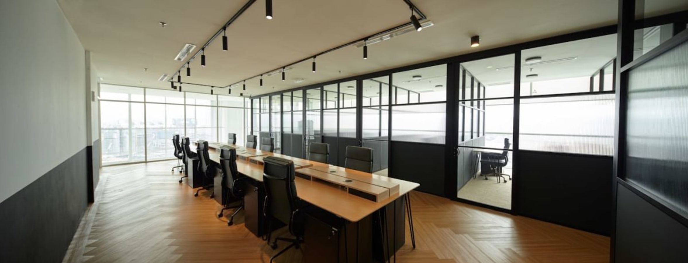 Modern coworking space with natural light and sleek furniture in Jalan Bukit Bintang.