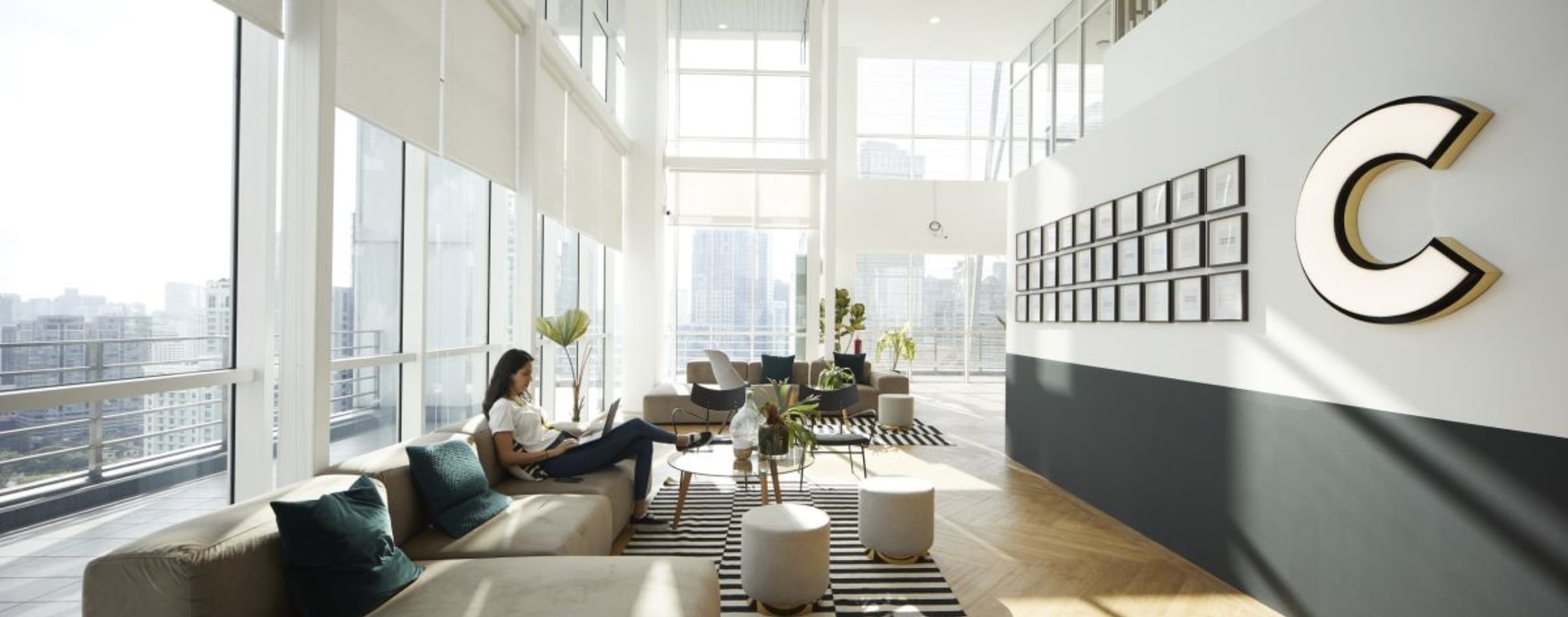 Bright, open coworking area with plush seating and city views in Jalan Bukit Bintang.