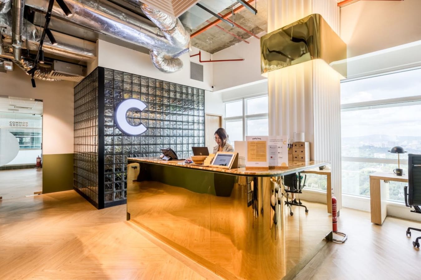 Modern coworking reception with chic design and ample natural light in Kuala Lumpur Sentral.