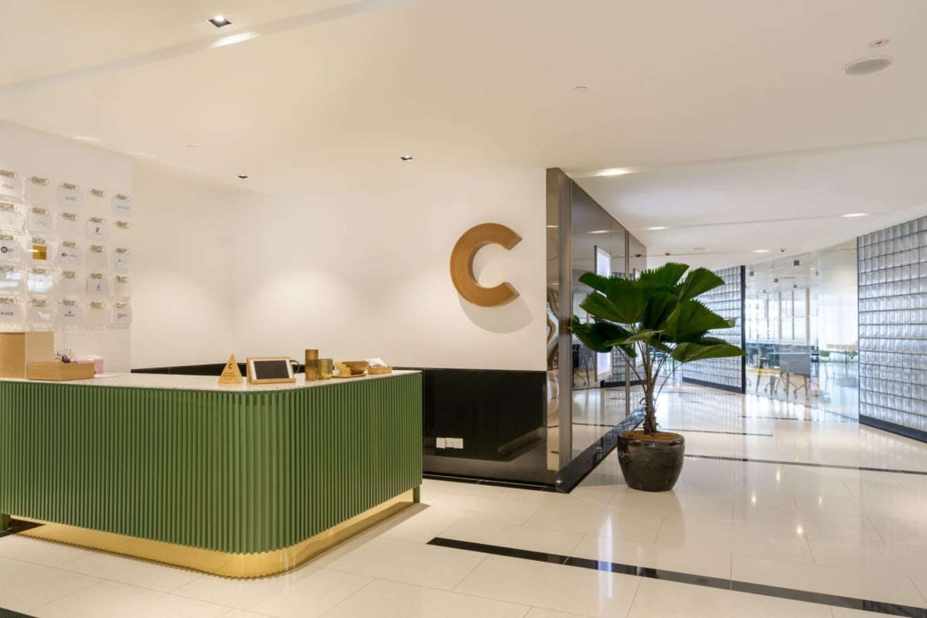 Modern coworking space with sleek decor, spacious layout, and lush plant accents.