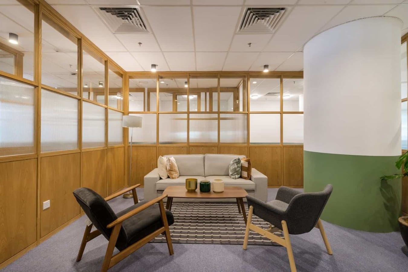 Chic coworking lounge with cozy seating, stylish decor, and ample natural light on Jalan Moulmein.