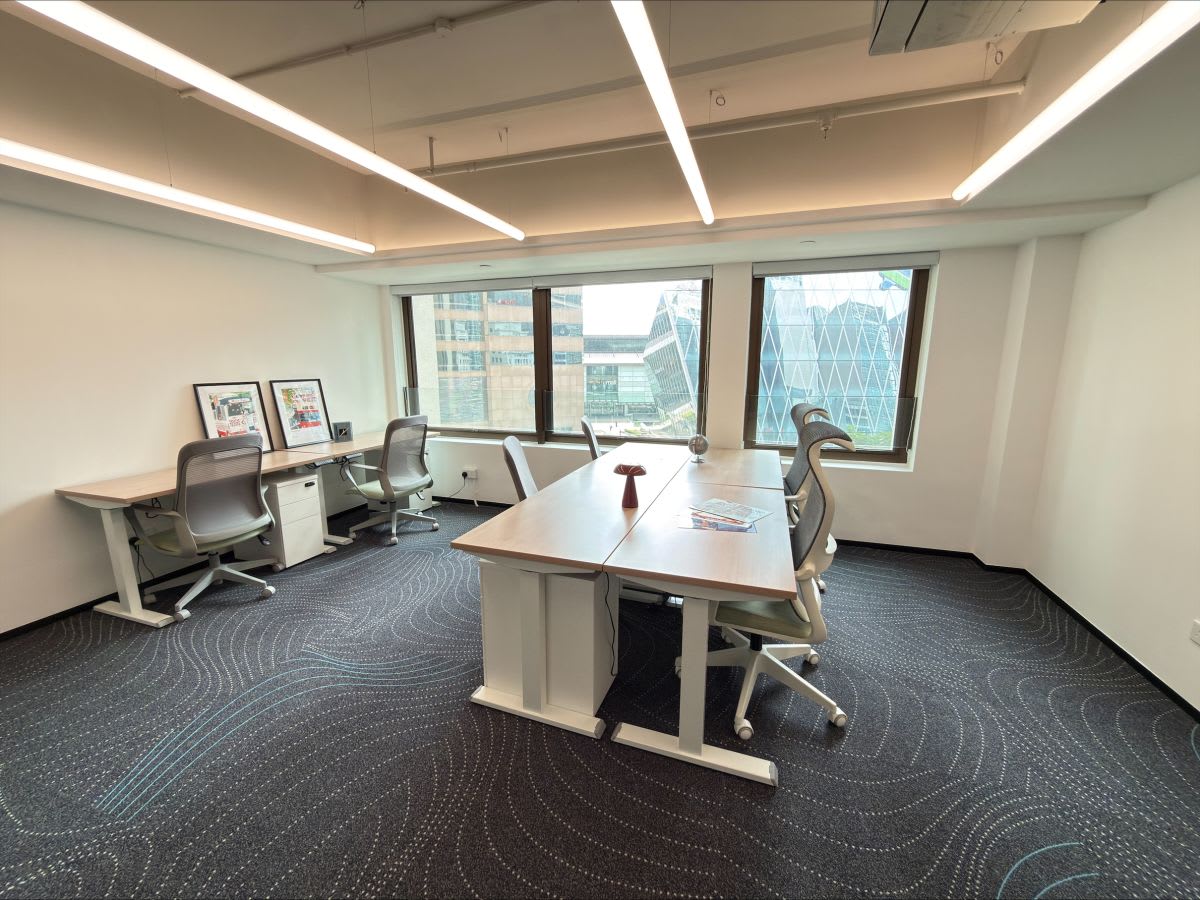 Bright coworking space with modern desks and ergonomic chairs. Stunning city views enhance creativity.