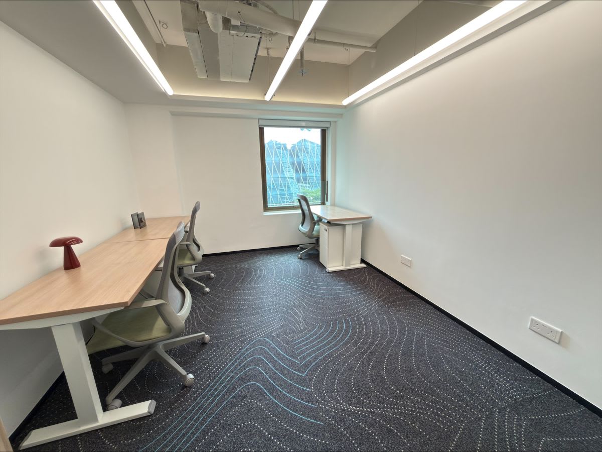 Bright, modern workspace with three desks and ergonomic chairs. Ideal for productivity.