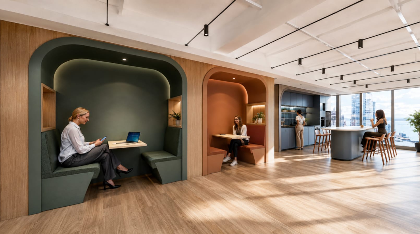 Modern coworking space with private booths, natural light, and a communal kitchen area.