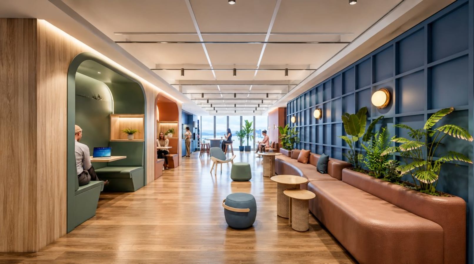 Modern coworking space with vibrant seating, natural lighting, and collaborative booths.