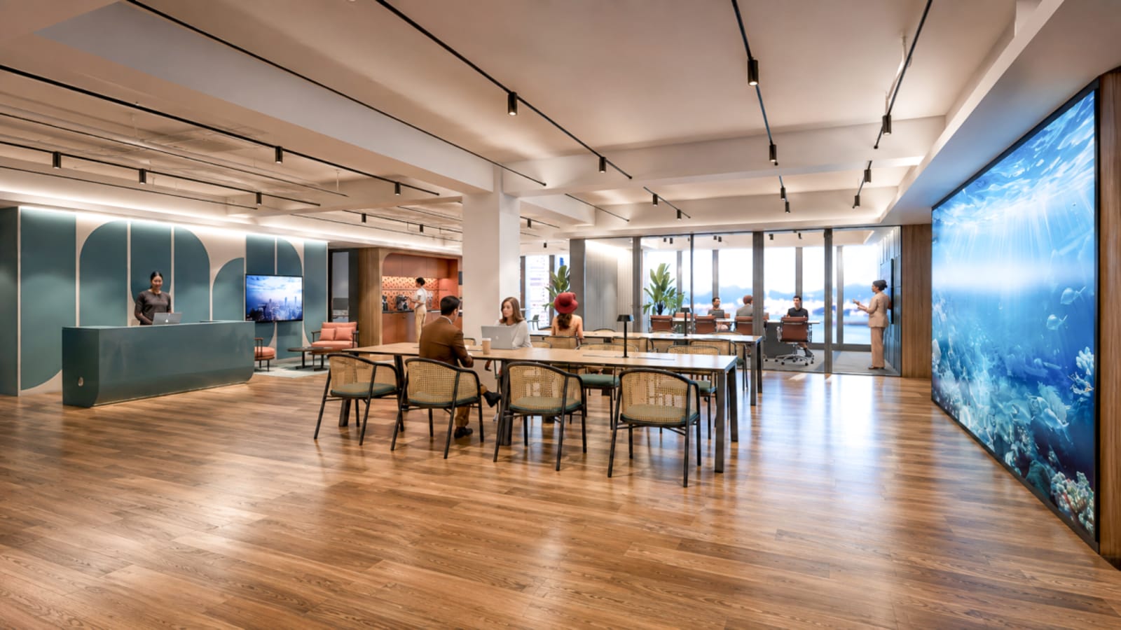 Stylish coworking space with ocean-inspired mural, open layout, and abundant natural light.