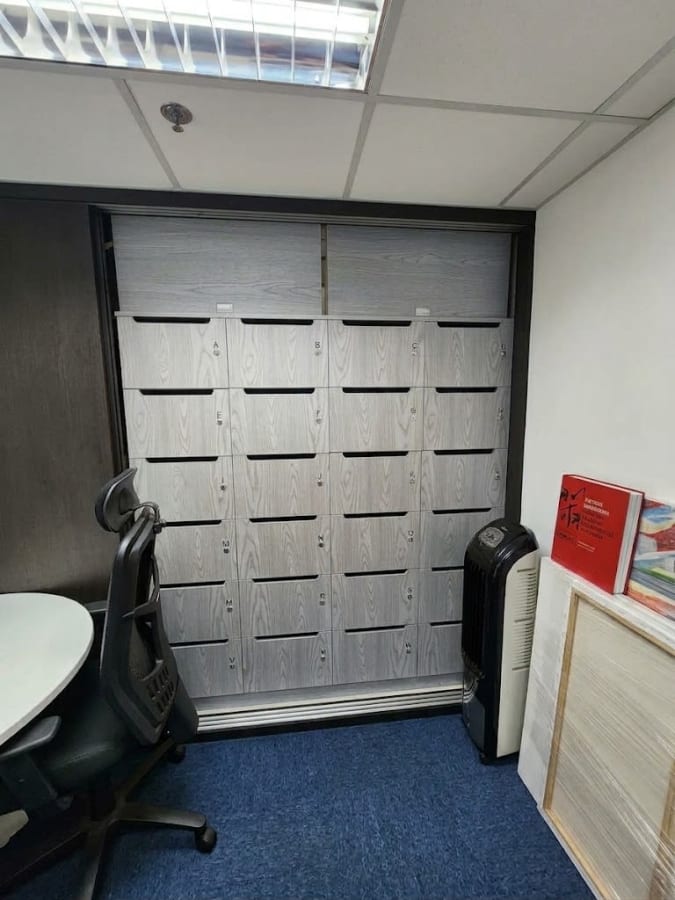 Compact workspace with secure storage and modern seating in a flexible coworking environment.