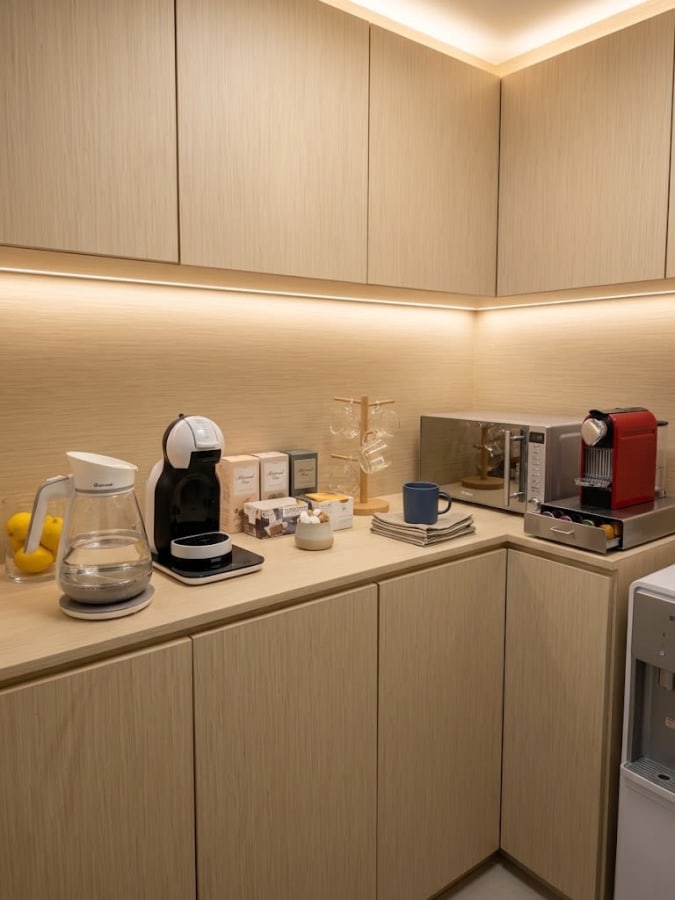 Modern coworking kitchenette with coffee machines and ample counter space in Hok Yuen.