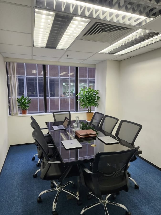Modern coworking meeting room with ample natural light and sleek furnishings in Hok Yuen.