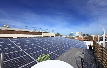 Roof top desk with solar panel array at Positive Energy Places