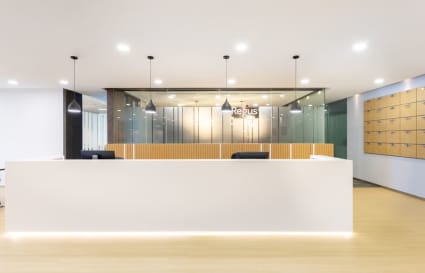 Sleek reception with modern lighting and secure lockers in a Marina Boulevard coworking space.
