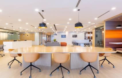 Modern coworking space with vibrant seating, ample lighting, and a collaborative layout.