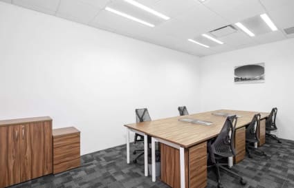 Sleek coworking space with modern desks and ergonomic chairs in Raffles Place, Singapore.