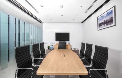 Sleek conference room with modern furnishings and natural light, ideal for dynamic meetings.