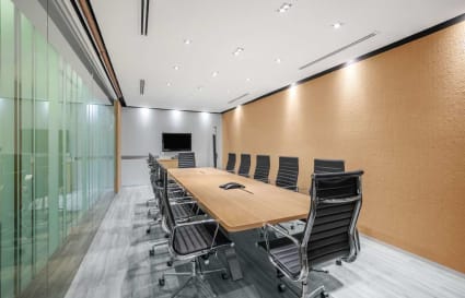 Sleek conference room with modern seating and a large table, ideal for collaborative meetings.