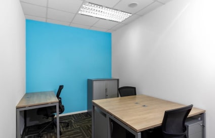 Modern coworking space with sleek desks, ergonomic chairs, and vibrant decor in Orchard Road.