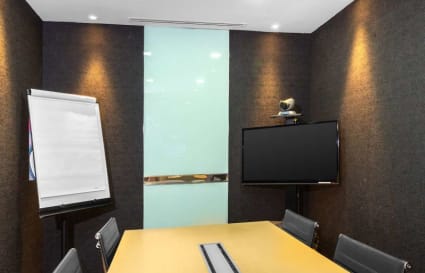 Modern meeting room with sleek table, ergonomic chairs, and presentation tools in Orchard Road space.