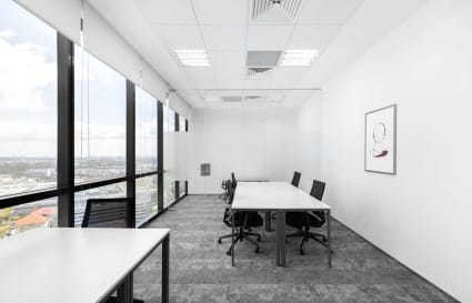 Bright, modern coworking space with large windows and versatile desk layouts in Venture Drive.