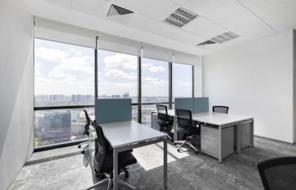 Bright coworking space with city views, modern desks, and ergonomic chairs at Venture Drive.