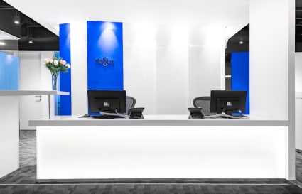 Sleek reception with modern design and ample lighting in a Thomson Road coworking space.