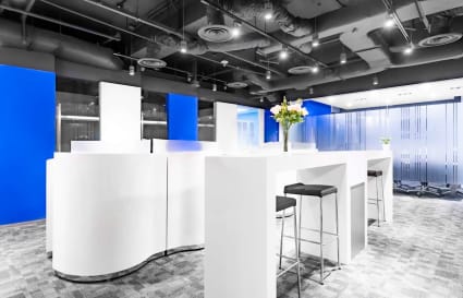 Modern coworking space on Thomson Road featuring sleek white furnishings and vibrant blue accents.