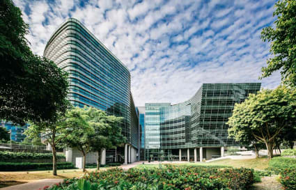 Modern coworking space in Changi Business Park, surrounded by lush greenery and striking architecture.