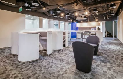 Modern coworking space with sleek furniture and open layout in Changi Business Park.