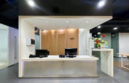 Modern reception area with sleek lighting and wood accents, perfect for welcoming clients.