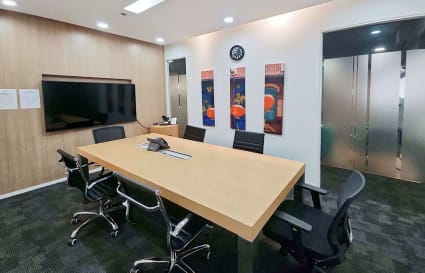 Modern conference room with sleek furnishings, ample lighting, and a vibrant decor.